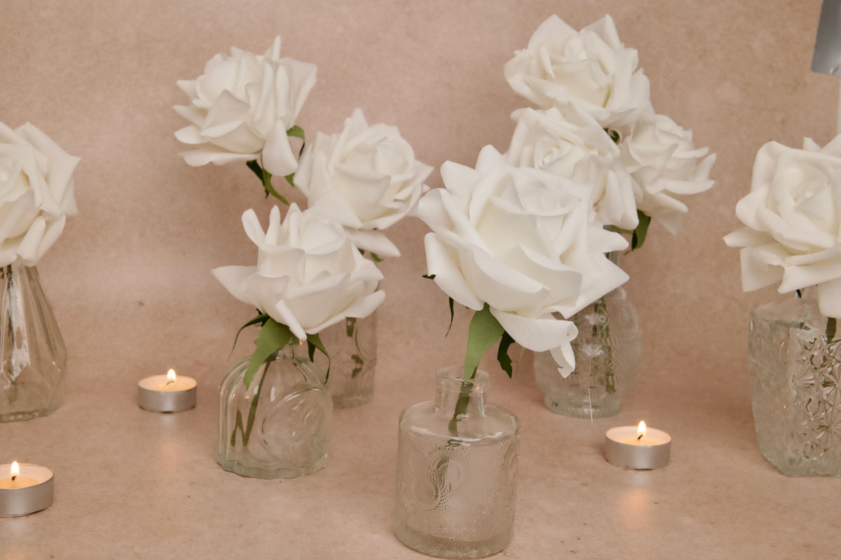 Elegant wedding table decorations with artificial, real-touch white roses